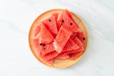 fresh watermelon sliced on wooden plate