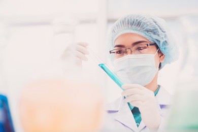 laboratory worker examining liquid in a test tube