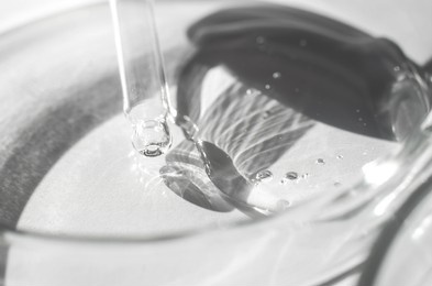 transparent cosmetic gel and pipette in a petri dish. close-up - the structure of the gel. laboratory research and development of body care cosmetics