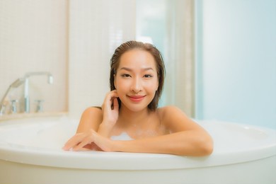portrait beautiful young asian woman relax smile in bathtub at bathroom interior
