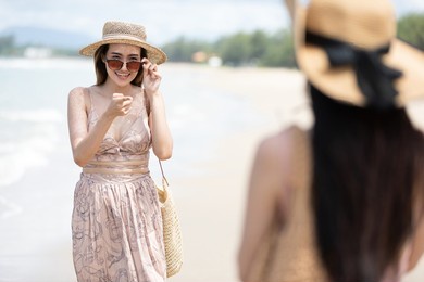 young woman meeting an old friend on the beach