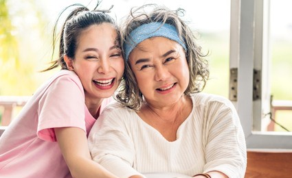 portrait of enjoy happy love asian family senior mature mother and young woman daughter smiling laughing embracing and having fun hug together.happy family in moments good time at home