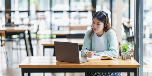 e-learning online education concept. asian woman attentive student student video conference e-learning with teacher on laptop computer at home
