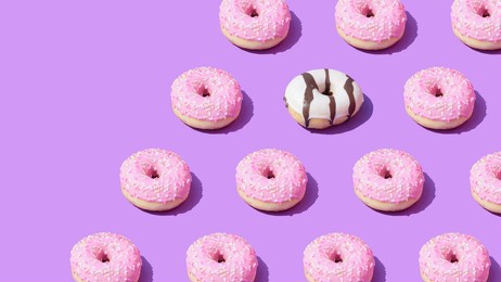 pink and white doughnuts pattern on a purple background with diagonal copy space trendy summer aesthetic backround. vibrant colors. sweet food donut visual concept.