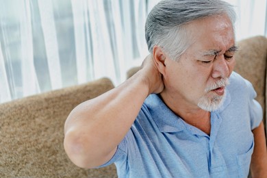 older asian man shoulder pain.