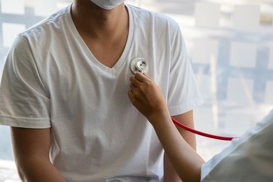 doctor using a stethoscope check the heartbeat in the doctor's examination room at the hospital. patients must undergo an annual health check-up for their health.