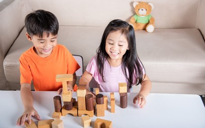 children boy and girl playing with constructor wooden block building, happy little kids play wood block stacking board game at home, activities learning creative, toys for preschool and kindergarten