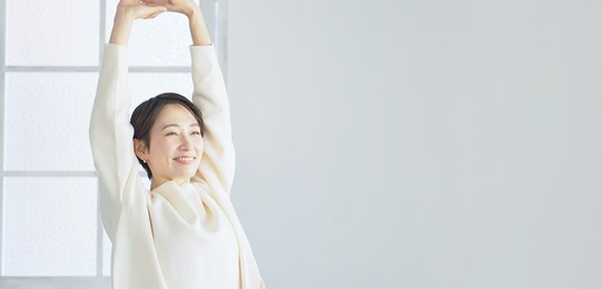 middle aged asian woman relaxing in the room.