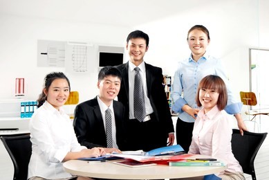 group of a happy successful business people in the office looking at camera.