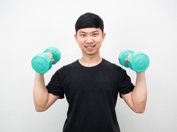 asian man holding dumbbell for exercise confident face