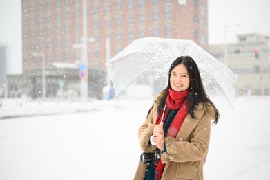 girl in umbrella and snowing