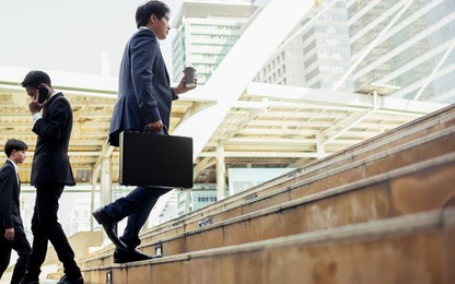 smart adult professional businesspeople carry briefcase, hurry or speed running, walking outdoor to work in morning. goal, job or career concept
