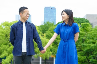 a young couple walking hand in hand