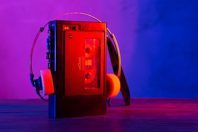 vintage cassette tape player in neon light. 90s advertisement style. disco party nostalgy concept