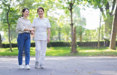 portrait of asian mother and daughter at park
