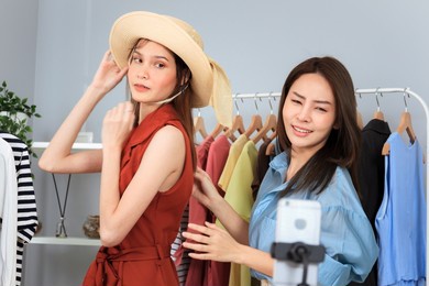 asian woman women making an online video live streaming on a smartphone. social media beauty blogger making a live stream on social network.