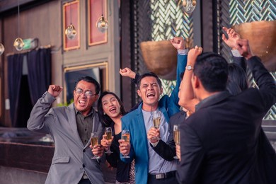 asian people group drinking in party congratulation business team ,group of friends enjoying evening drinks in bar