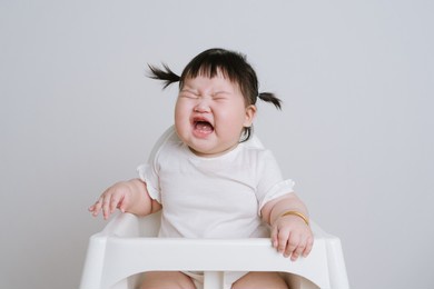 a half-year-old little girl photographed on a pure white background