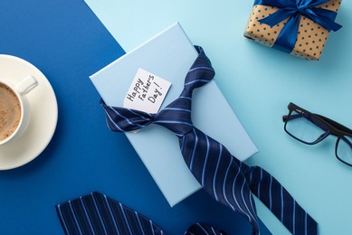 father's day concept. top view photo of blue necktie gift boxes postcard glasses and cup of coffee on saucer on bicolor blue background