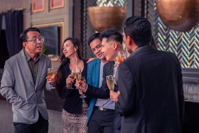 asian people group drinking in party congratulation business team ,group of friends enjoying evening drinks in bar