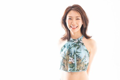 asian swimsuit model wearing a black 2 piece bathing suit on a white background