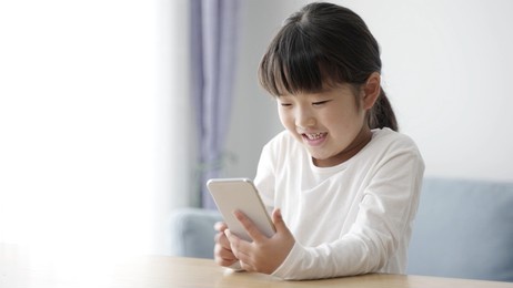 asian girl using smartphone in the living room