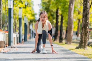 asian female sport woman athlete tying laces for jogging on road in the park running shoes at public park . active asian woman tying shoe lace before running woman tying shoe laces.