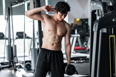 young man in sportswear exercising at the gym