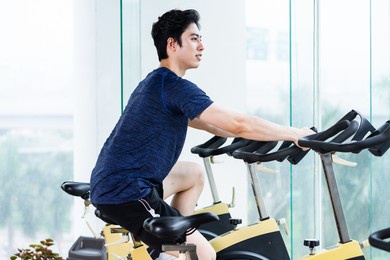 young man in sportswear exercising at the gym