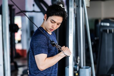 young man in sportswear exercising at the gym