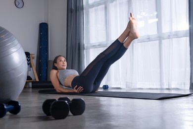 sporty young asian woman doing yoga in living room, young female in sportswear exercising at home, watching online fitness class, training in living room