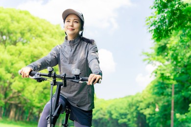 asian woman with mini velo bicycle. cycling in nature.