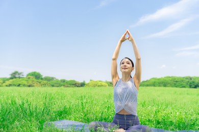 asian woman doing yoga in green park. park yoga. mindfulness.