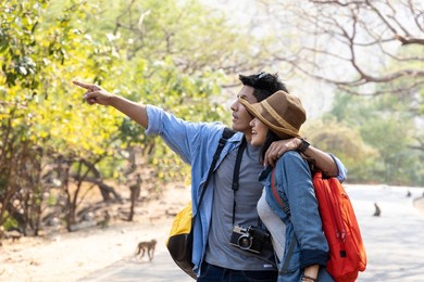 asian young couple hiking in forest during summer