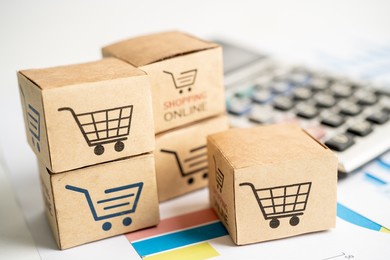 shopping online box with credit card and calculator on graph. finance commerce import export business concept.