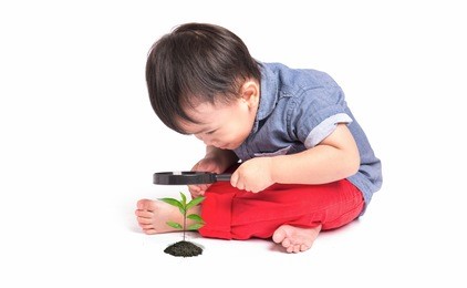 happy kid with magnifying glass, exploring the environment isolated on white background