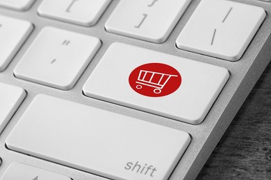 online store. button with shopping cart on computer keyboard, closeup