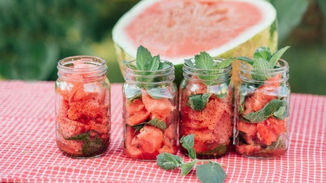 watermelon and mint infused detox water. lemonade with ice and mint as summer refreshing drink in jars. cold soft drinks with fruit. refreshing red summer juice
