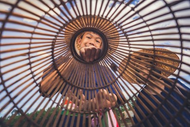 children finding fish on tradition tool for catch fish in rice field of rural
