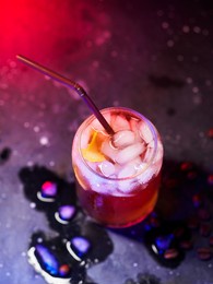 cold espresso coffee tonic on a dark table, neon light. refreshing summer drink