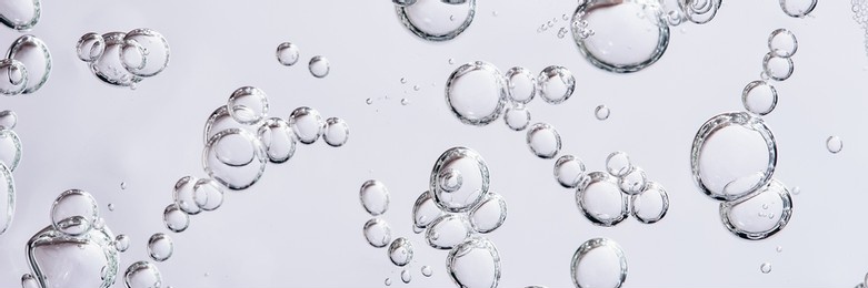 close up macro aloe vera gel serum cosmetic texture blue background with bubbles. cruelty free. lemongrass gel skincare product. antibacterial liquid with aloe vera, moisturizing.