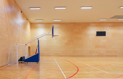 gym with a mobile basketball hoop and goals for handball and futsal
