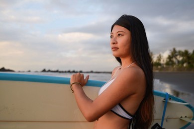 lifestyle women travel on beach concept., beautiful female holding surfoard 
happy relax walking on beach near sea 


