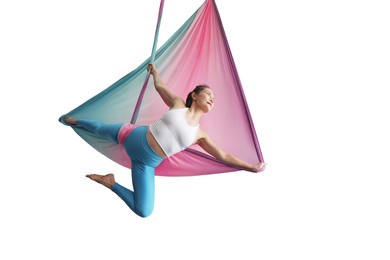 mature woman pose in hammock performing aerial yoga or flying yoga exercise isolated on white background. healthy lifestyle and emotional health of middle aged people concepts.