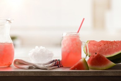 watermelon slush with sliced fruit and crushed ice in a bowl on wooden table in a kitchen. front view. horizontal composition.