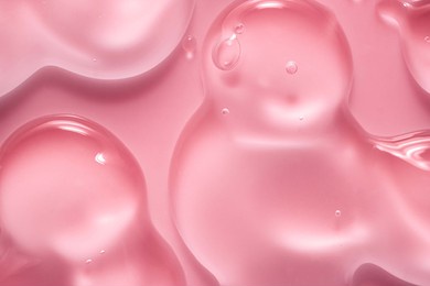 cream gel drops red transparent cosmetic sample texture with bubbles on pink background