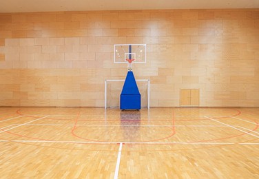 handball goal and movable basketball basket in the gym