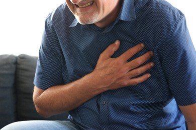 caucasian man middle age suffering from heart attack at home