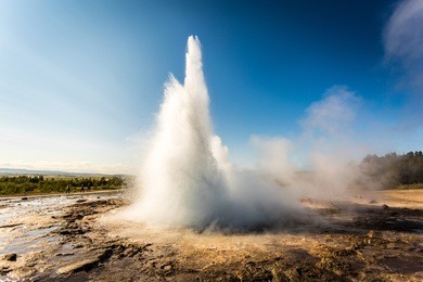 stokkur geyser eruption, iceland. blue sky in a sunny day, landscape view. geysir