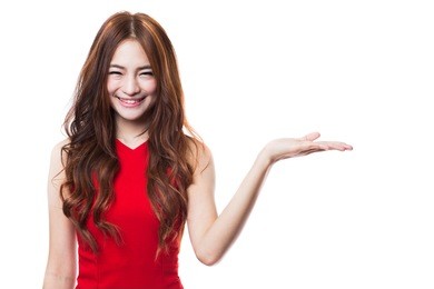 beautiful young woman in red dress presenting with  open hand palm on white background